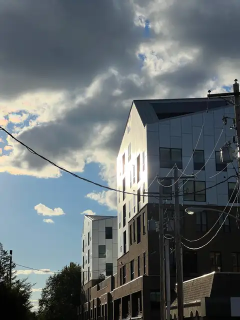 Sun-kissed modern buildings against a moody sky.